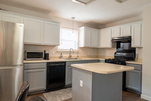 1818 W Pflugerville Pkwy, Round Rock, TX 78664 - kitchen featuring appliances with stainless steel finishes, under cabinet range hood, light countertops, dark wood-style flooring, and gray cabinets