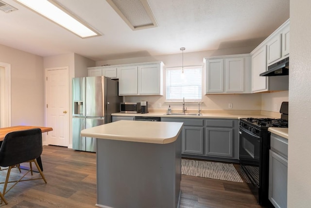 1818 W Pflugerville Pkwy, Round Rock, TX 78664 - kitchen with appliances with stainless steel finishes, under cabinet range hood, light countertops, and dark wood-type flooring