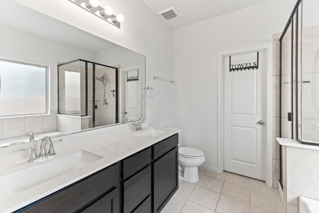 6010 Principale Dr, Pflugerville, TX 78660 - bathroom featuring a stall shower, double vanity, toilet, tile patterned flooring, and a tub