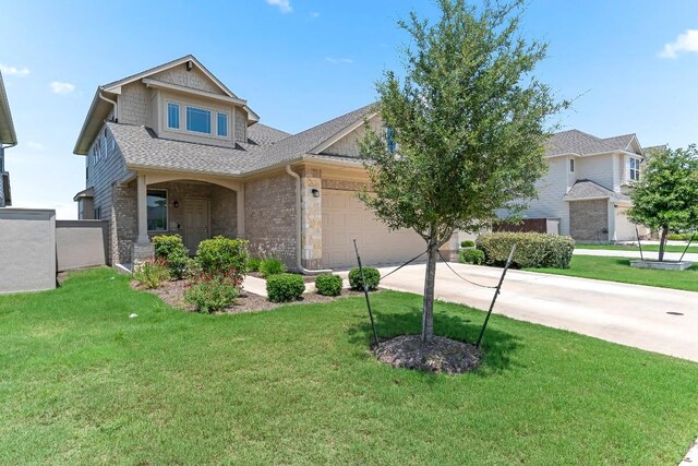 6010 Principale Dr, Pflugerville, TX 78660 - view of front of home with concrete driveway, an attached garage, a shingled roof, and a front yard