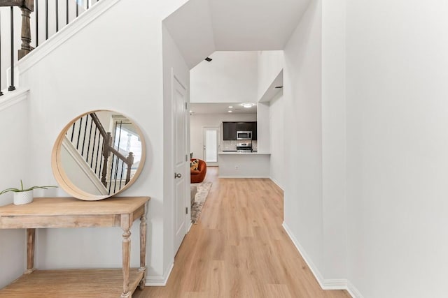 6010 Principale Dr, Pflugerville, TX 78660 - corridor featuring light wood-type flooring, stairs, and high vaulted ceiling