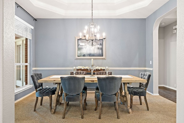 1518 Foppiano Loop, Round Rock, TX 78665 - dining space with carpet, a chandelier, a tray ceiling, arched walkways, and baseboards