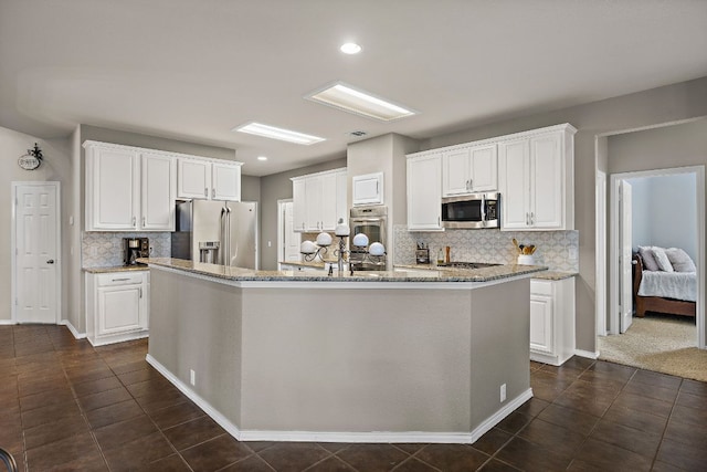 1518 Foppiano Loop, Round Rock, TX 78665 - kitchen with stainless steel appliances, backsplash, white cabinets, and recessed lighting