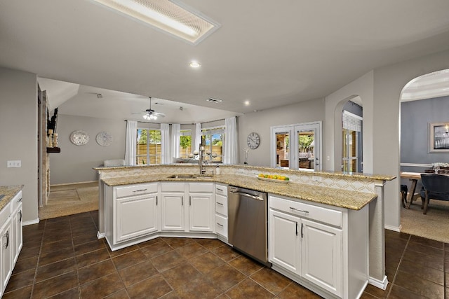 1518 Foppiano Loop, Round Rock, TX 78665 - kitchen featuring dishwasher, a ceiling fan, arched walkways, a sink, and light stone counters