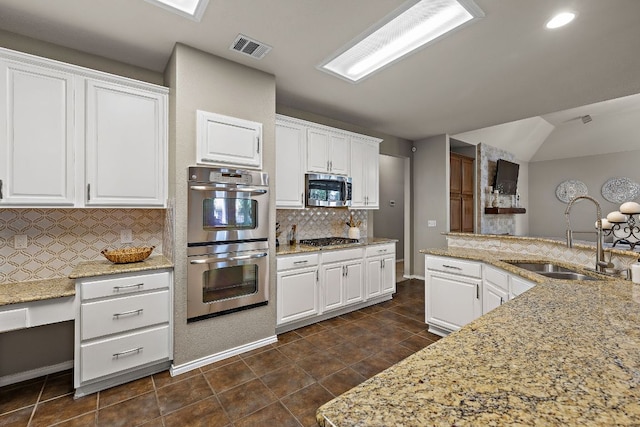 1518 Foppiano Loop, Round Rock, TX 78665 - kitchen with a sink, stainless steel appliances, tasteful backsplash, white cabinets, and recessed lighting