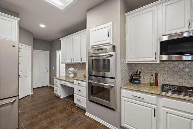 1518 Foppiano Loop, Round Rock, TX 78665 - kitchen with stainless steel appliances, decorative backsplash, white cabinetry, light stone counters, and recessed lighting