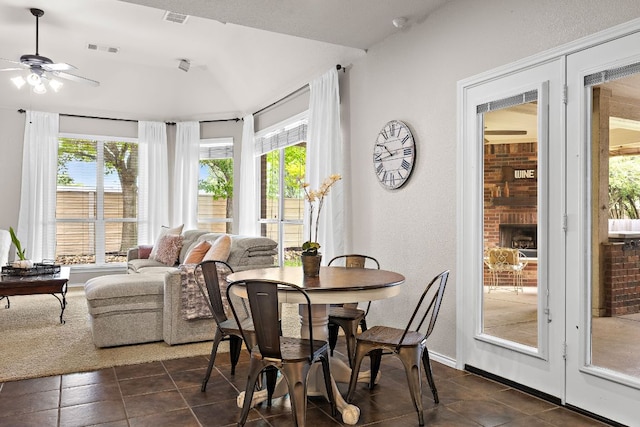 1518 Foppiano Loop, Round Rock, TX 78665 - dining area featuring healthy amount of natural light, ceiling fan, dark tile patterned floors, and a textured wall