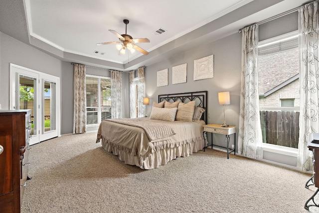 1518 Foppiano Loop, Round Rock, TX 78665 - bedroom featuring carpet floors, a tray ceiling, crown molding, and ceiling fan