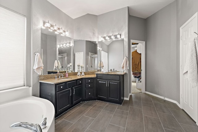 1518 Foppiano Loop, Round Rock, TX 78665 - bathroom with double vanity, a shower stall, a bath, baseboards, and wood finish floors