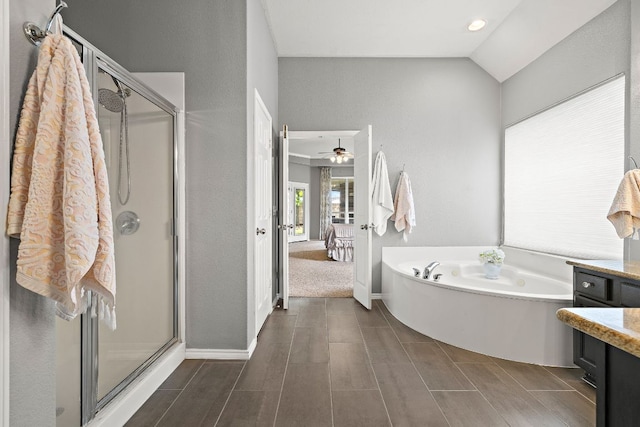 1518 Foppiano Loop, Round Rock, TX 78665 - full bathroom with a bath, a stall shower, vanity, vaulted ceiling, and a ceiling fan