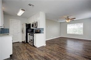 6205 Hyside Dr, Austin, TX 78723 - kitchen featuring appliances with stainless steel finishes, ceiling fan, dark wood-style floors, white cabinets, and baseboards