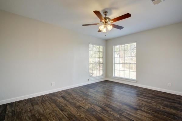 6205 Hyside Dr, Austin, TX 78723 - spare room featuring dark wood finished floors, baseboards, and a ceiling fan