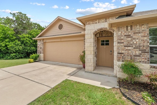 2211 Bettylou Ln, Austin, TX 78754 - view of front of house featuring a garage, concrete driveway, and stone siding