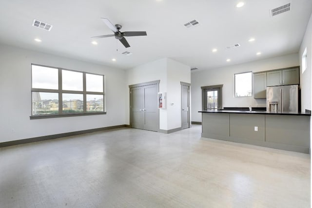 2211 Bettylou Ln, Austin, TX 78754 - kitchen with stainless steel refrigerator with ice dispenser, dark countertops, ceiling fan, open floor plan, and recessed lighting