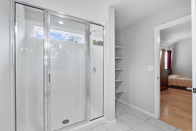 2211 Bettylou Ln, Austin, TX 78754 - ensuite bathroom with a stall shower, tile patterned flooring, and baseboards