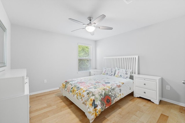 2211 Bettylou Ln, Austin, TX 78754 - bedroom with light wood-style flooring, baseboards, and a ceiling fan