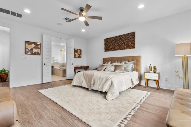 1329 Da Vinci Trl, Leander, TX 78641 - bedroom featuring light wood-style flooring, recessed lighting, ensuite bathroom, and a ceiling fan
