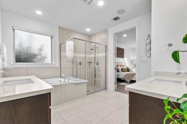 1329 Da Vinci Trl, Leander, TX 78641 - ensuite bathroom featuring double vanity, a stall shower, a garden tub, and recessed lighting
