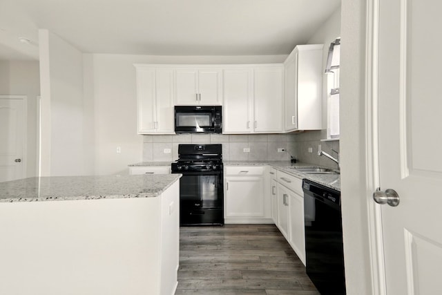 112 Black Alder St, Georgetown, TX 78626 - kitchen featuring black appliances, a sink, wood finished floors, light stone countertops, and decorative backsplash