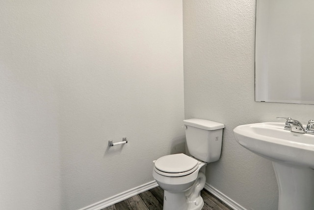 112 Black Alder St, Georgetown, TX 78626 - bathroom featuring wood finished floors, toilet, baseboards, and a sink