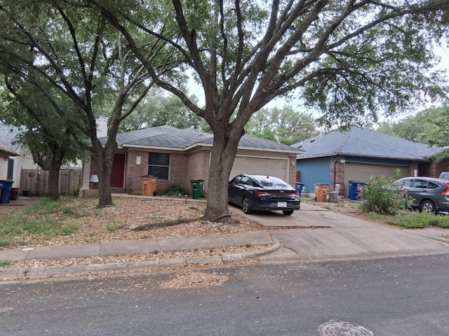 901 Calico Dr, Austin, TX 78748 - single story home with an attached garage, brick siding, and concrete driveway