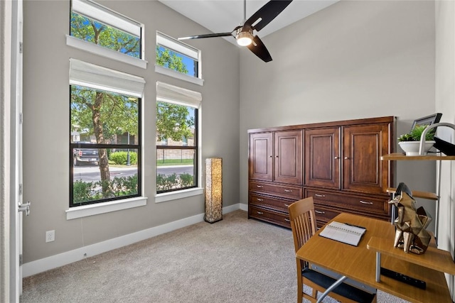 1017 Sue Ann Rose Dr, Austin, TX 78717 - home office with a high ceiling, ceiling fan, light carpet, and baseboards