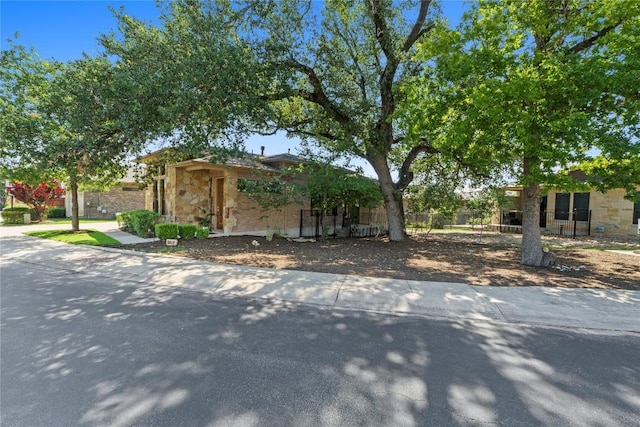1017 Sue Ann Rose Dr, Austin, TX 78717 - obstructed view of property with stone siding