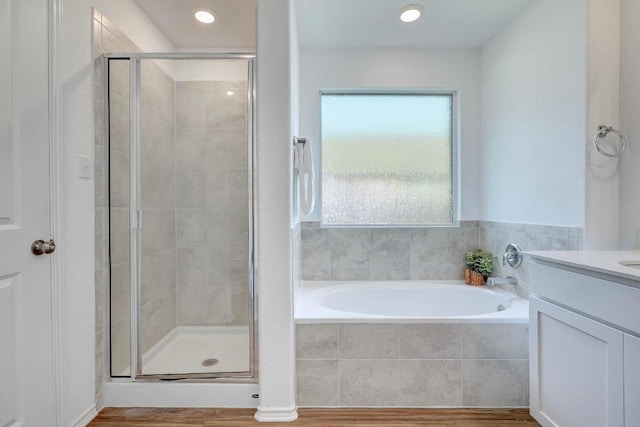 3109 Windy Vane Dr, Pflugerville, TX 78660 - bathroom featuring a bath, a shower stall, vanity, and wood finished floors