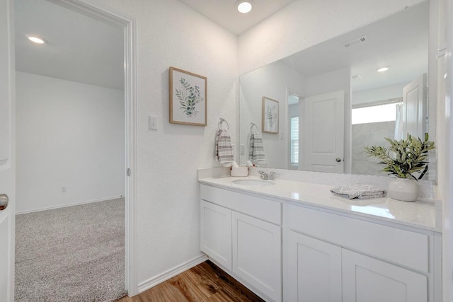 3109 Windy Vane Dr, Pflugerville, TX 78660 - bathroom featuring vanity, baseboards, wood finished floors, and recessed lighting