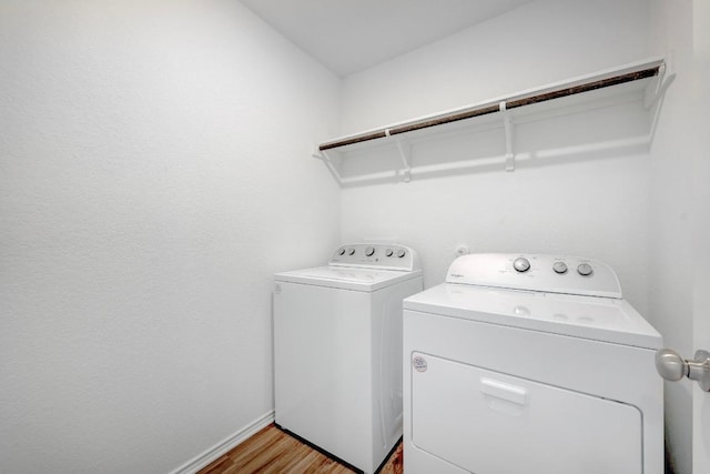 3109 Windy Vane Dr, Pflugerville, TX 78660 - laundry room with washing machine and dryer, baseboards, and light wood-type flooring