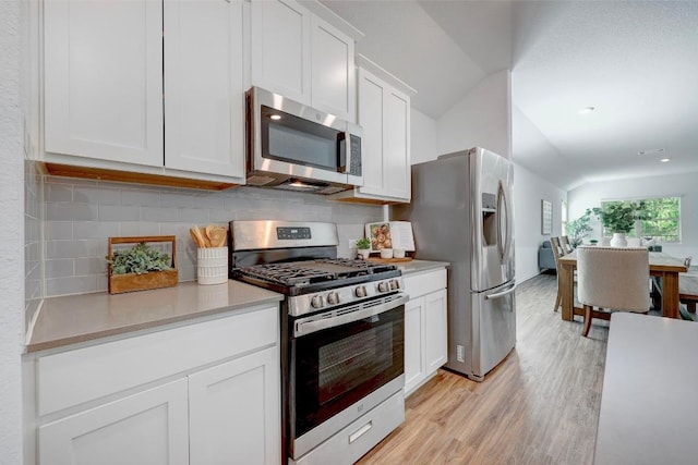 3109 Windy Vane Dr, Pflugerville, TX 78660 - kitchen featuring appliances with stainless steel finishes, light wood-type flooring, tasteful backsplash, light countertops, and white cabinets