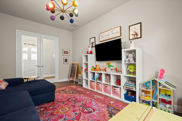 18621 James Power Ct, Austin, TX 78738 - living area featuring a chandelier, french doors, and baseboards
