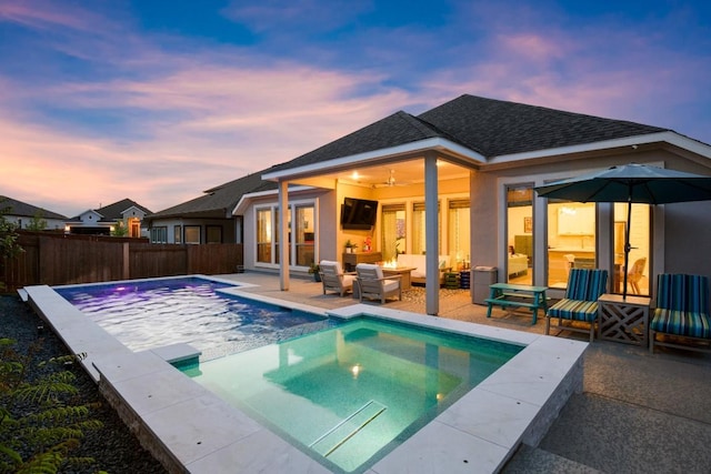18621 James Power Ct, Austin, TX 78738 - back of house at dusk featuring a patio area, a fenced backyard, roof with shingles, and stucco siding