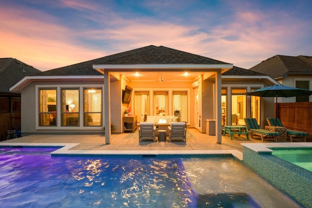 18621 James Power Ct, Austin, TX 78738 - back of property with a patio, an outdoor living space, a shingled roof, stucco siding, and a pool with connected hot tub