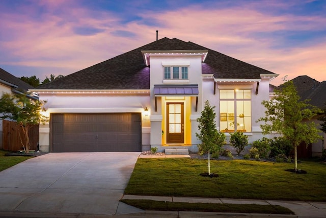 18621 James Power Ct, Austin, TX 78738 - view of front of home featuring stucco siding, a shingled roof, concrete driveway, an attached garage, and a standing seam roof