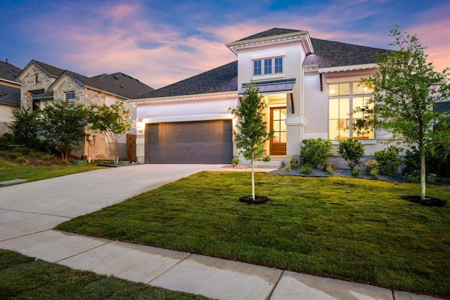 18621 James Power Ct, Austin, TX 78738 - view of front of property with stucco siding, an attached garage, driveway, and a front lawn