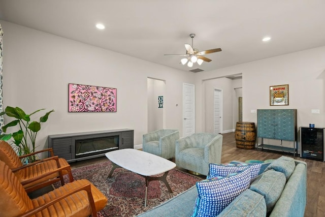 18621 James Power Ct, Austin, TX 78738 - living area with wood finished floors, a glass covered fireplace, ceiling fan, recessed lighting, and baseboards