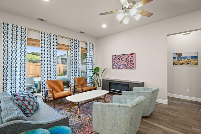 18621 James Power Ct, Austin, TX 78738 - living room with baseboards, wood finished floors, recessed lighting, ceiling fan, and a glass covered fireplace