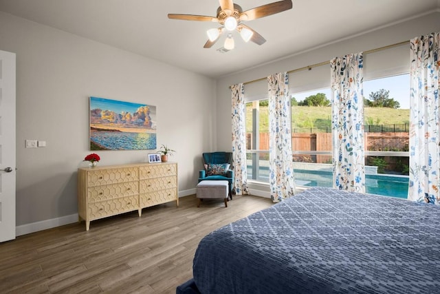 18621 James Power Ct, Austin, TX 78738 - bedroom with baseboards, wood finished floors, and a ceiling fan