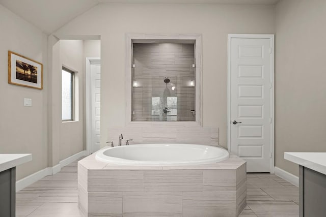 18621 James Power Ct, Austin, TX 78738 - bathroom with vanity, a garden tub, tiled shower, baseboards, and lofted ceiling