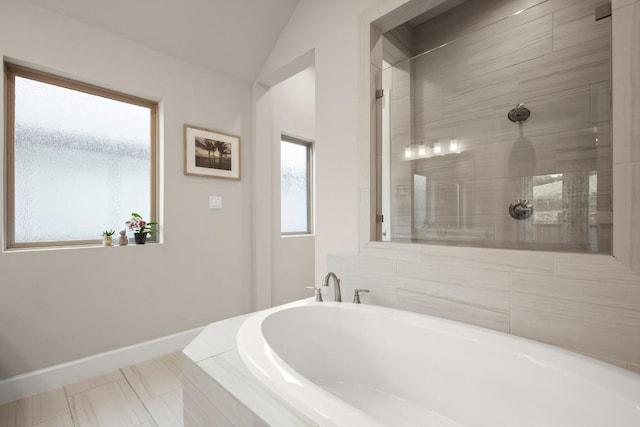 18621 James Power Ct, Austin, TX 78738 - bathroom with a garden tub, baseboards, lofted ceiling, and tiled shower