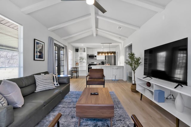 1205 Arthur Stiles Rd, Austin, TX 78721 - living area with healthy amount of natural light, light wood finished floors, and a ceiling fan