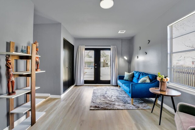 1205 Arthur Stiles Rd, Austin, TX 78721 - living area featuring wood finished floors, french doors, and baseboards