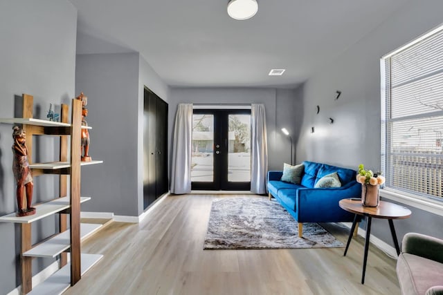 1205 Arthur Stiles Rd, Austin, TX 78721 - living area featuring wood finished floors and french doors
