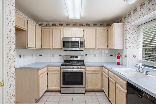 12303 Shropshire Blvd, Austin, TX 78753 - kitchen with appliances with stainless steel finishes, light brown cabinets, a sink, light countertops, and wallpapered walls