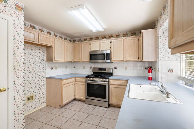 12303 Shropshire Blvd, Austin, TX 78753 - kitchen with stainless steel appliances, light brown cabinetry, a sink, light tile patterned flooring, and light countertops
