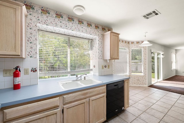 12303 Shropshire Blvd, Austin, TX 78753 - kitchen featuring dishwasher, a sink, light brown cabinets, wallpapered walls, and plenty of natural light