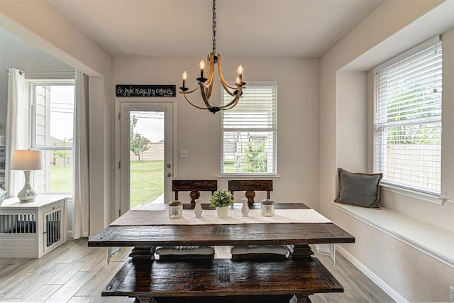20517 Kangal Ct, Pflugerville, TX 78660 - dining room featuring a chandelier, light wood finished floors, and baseboards