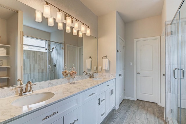 20517 Kangal Ct, Pflugerville, TX 78660 - full bath featuring double vanity, a stall shower, and wood finished floors