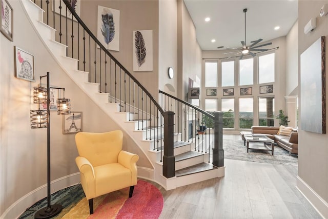 5400 Alonso Dr, Austin, TX 78738 - staircase with a towering ceiling, wood finished floors, baseboards, ceiling fan, and recessed lighting